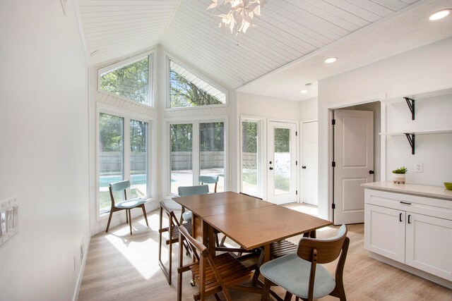 dining space with high vaulted ceiling, light hardwood / wood-style floors, and wooden ceiling