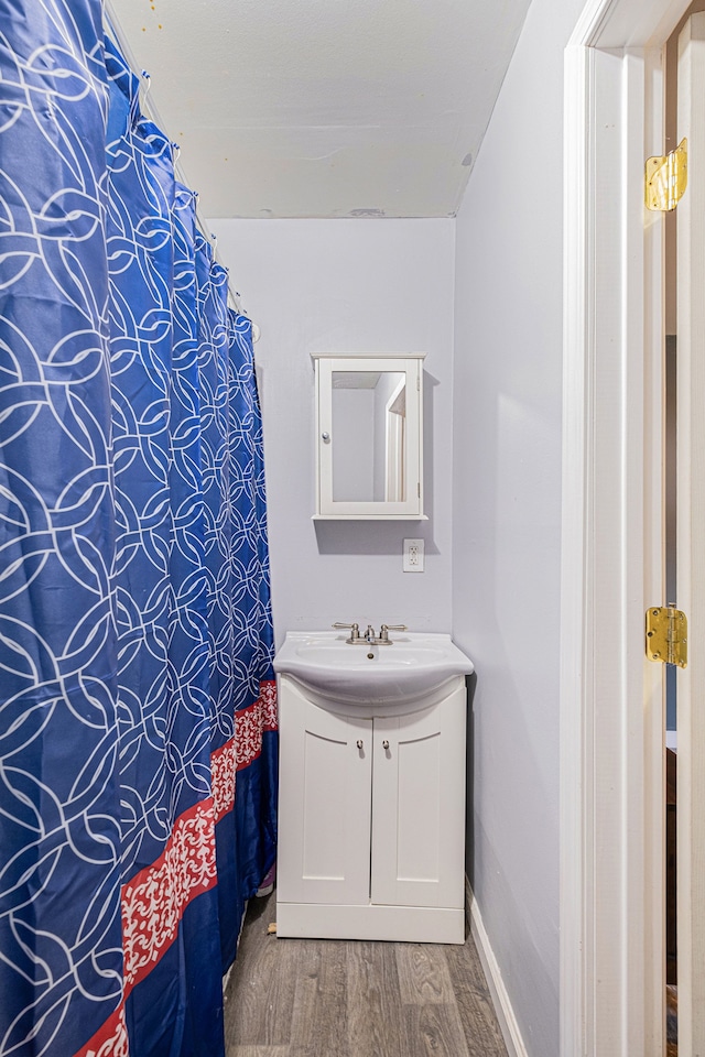 bathroom with wood-type flooring and vanity