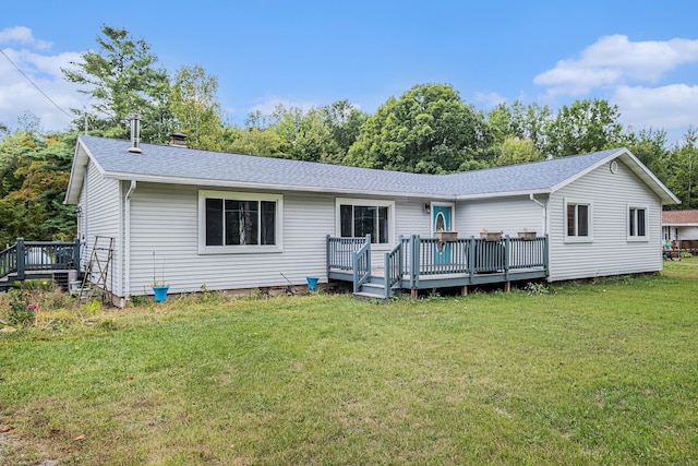 rear view of property with a lawn and a deck