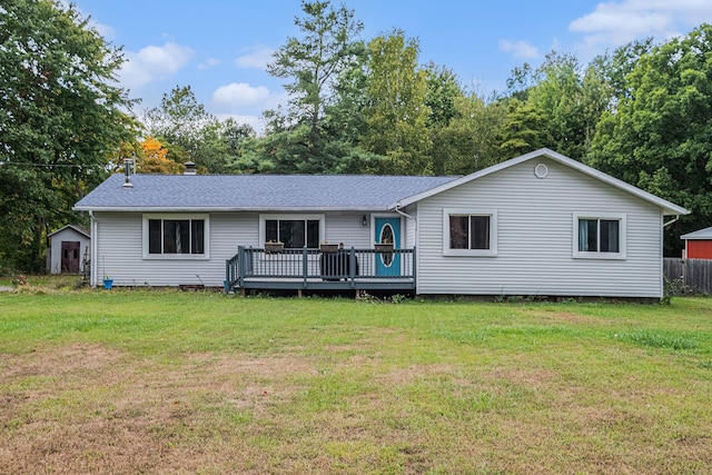 back of house featuring a lawn and a wooden deck