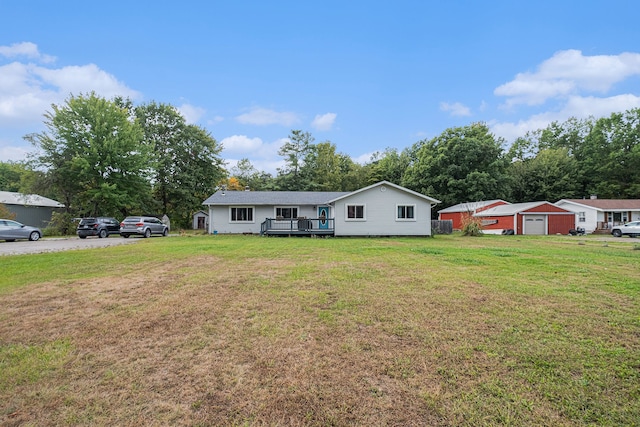 view of front of property featuring a front lawn and a deck