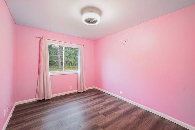 empty room with dark hardwood / wood-style floors