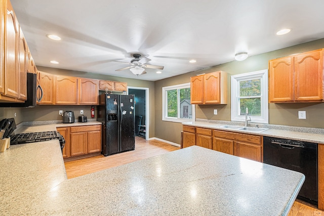 kitchen with ceiling fan, sink, black appliances, and light wood-type flooring