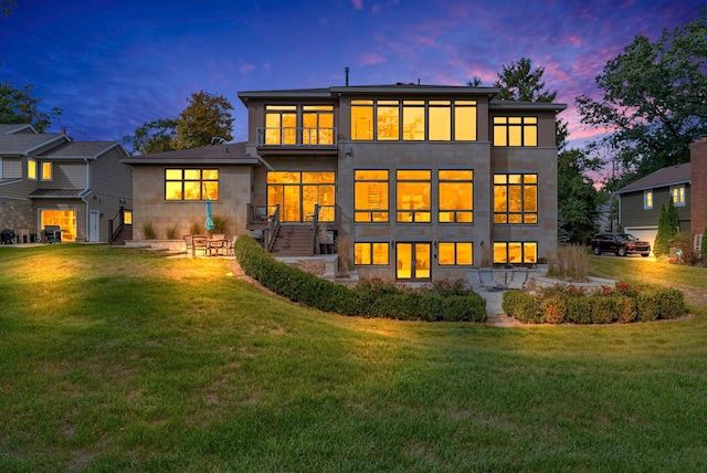 back house at dusk with a yard