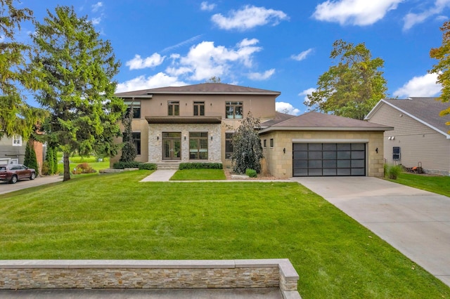 view of front of home with a front yard and a garage