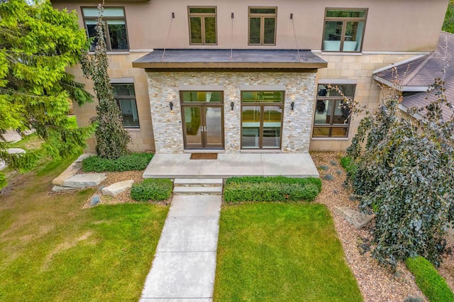 doorway to property with a lawn