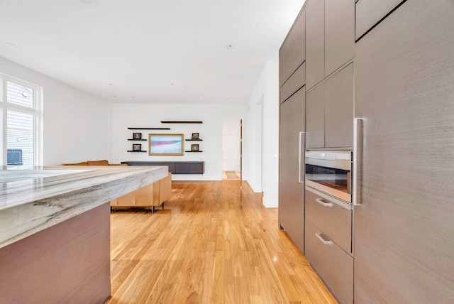 kitchen with light hardwood / wood-style flooring and gray cabinetry