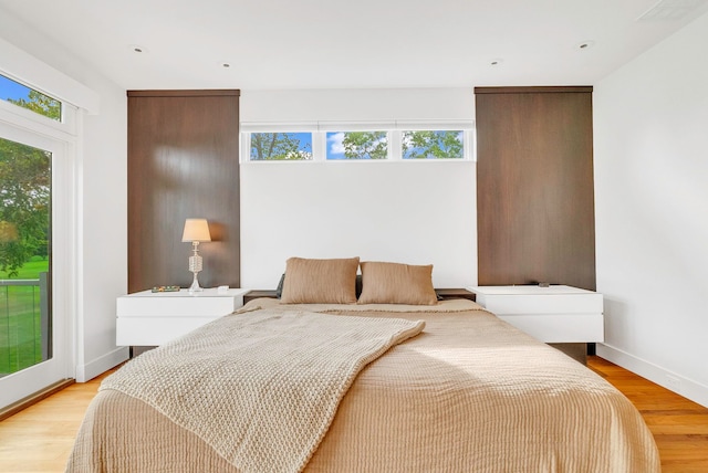 bedroom featuring access to outside and light hardwood / wood-style flooring