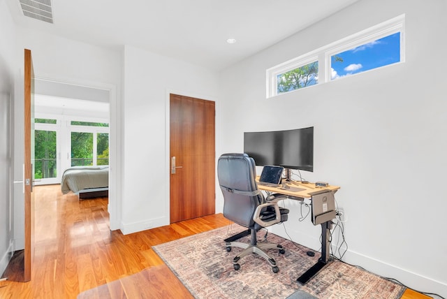 office with light wood-type flooring