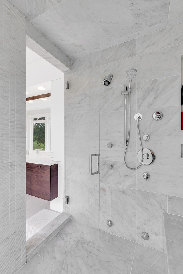 bathroom with vanity and a shower with door