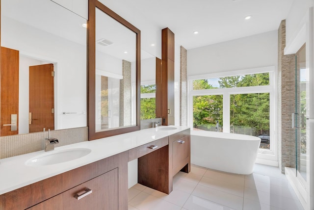 bathroom featuring tile patterned flooring, vanity, and independent shower and bath