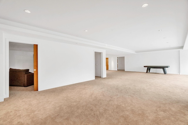 basement featuring light carpet