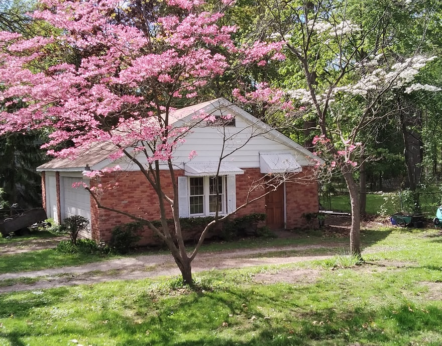 view of home's exterior featuring a yard and a garage