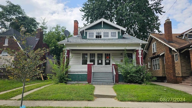 bungalow-style home with a porch and a front yard