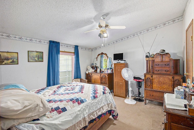 carpeted bedroom featuring ceiling fan and a textured ceiling