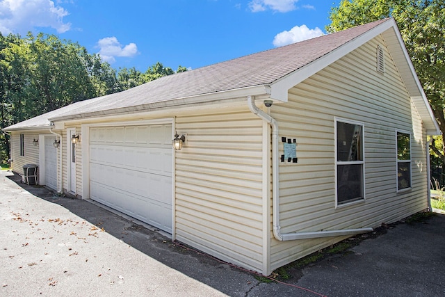 view of property exterior featuring an outbuilding and a garage