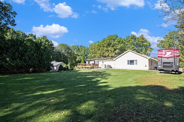 view of yard featuring central AC unit and a deck