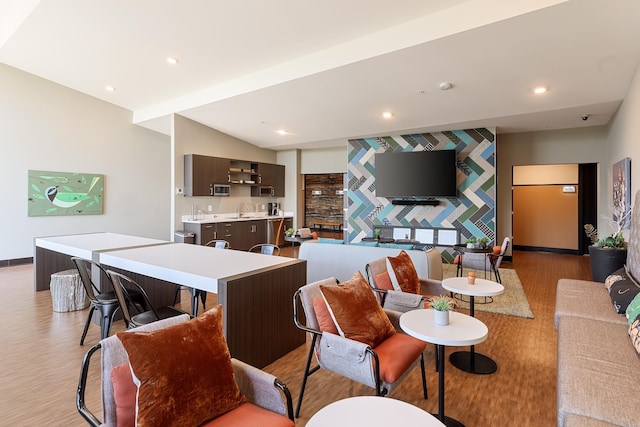 living room featuring sink and light hardwood / wood-style flooring