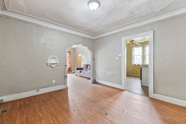 unfurnished room featuring ceiling fan, a textured ceiling, and hardwood / wood-style flooring