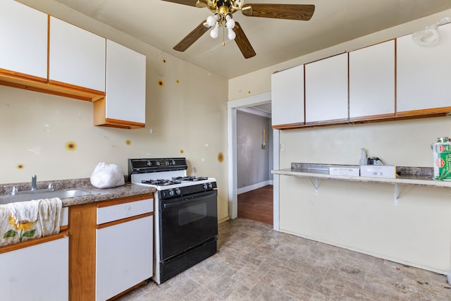 kitchen with ceiling fan, sink, white cabinetry, and black range with gas cooktop