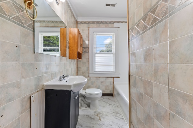 bathroom with vanity, crown molding, tile walls, and a wealth of natural light