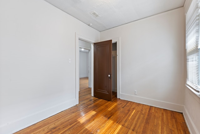 spare room featuring wood-type flooring