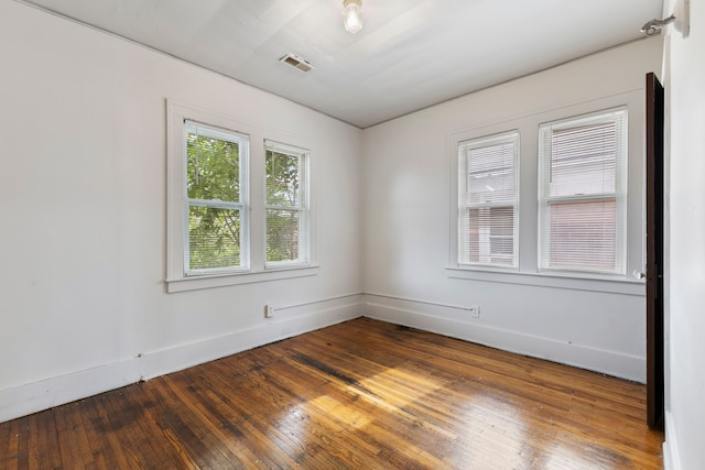 spare room featuring dark wood-type flooring