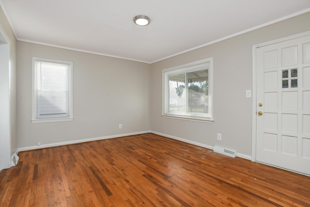 foyer entrance featuring crown molding and dark hardwood / wood-style flooring