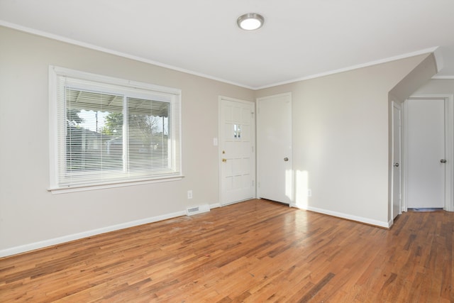 entrance foyer featuring wood-type flooring and crown molding