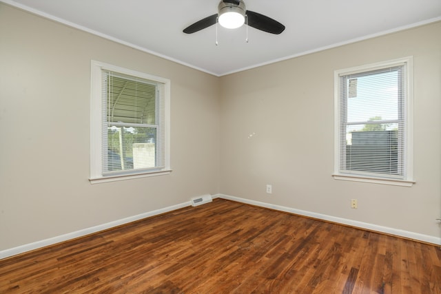 unfurnished room with crown molding, ceiling fan, and dark wood-type flooring