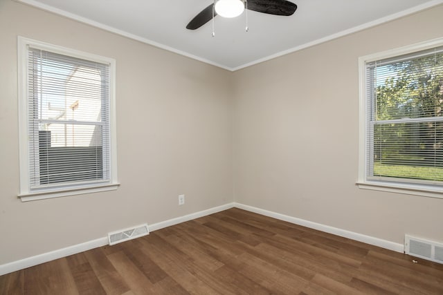 empty room with ceiling fan, a healthy amount of sunlight, dark hardwood / wood-style flooring, and ornamental molding