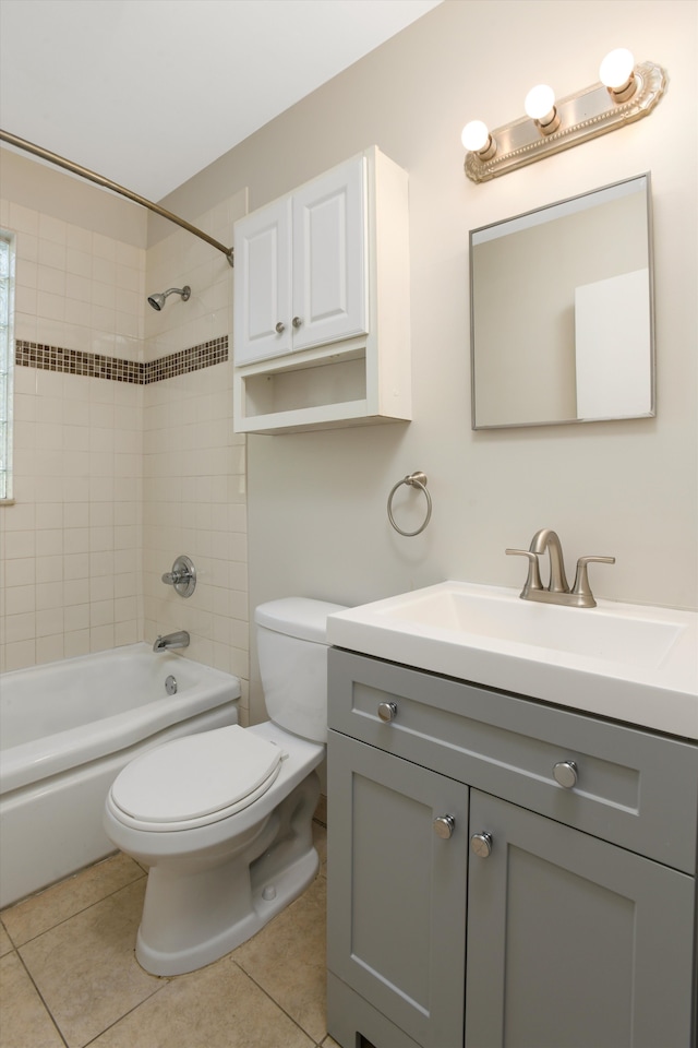 full bathroom with tile patterned flooring, vanity, toilet, and tiled shower / bath