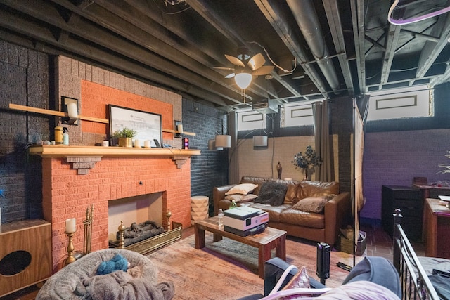 interior space featuring a brick fireplace, brick wall, and hardwood / wood-style flooring