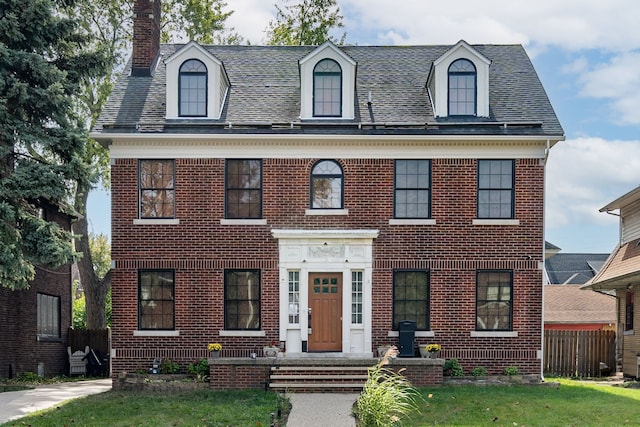 colonial home with a front lawn