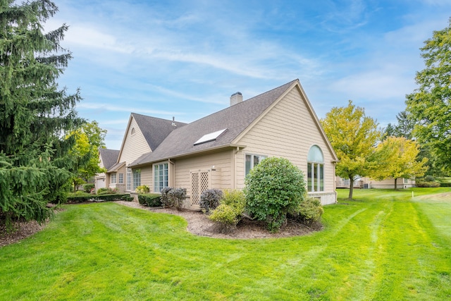 view of property exterior with a yard