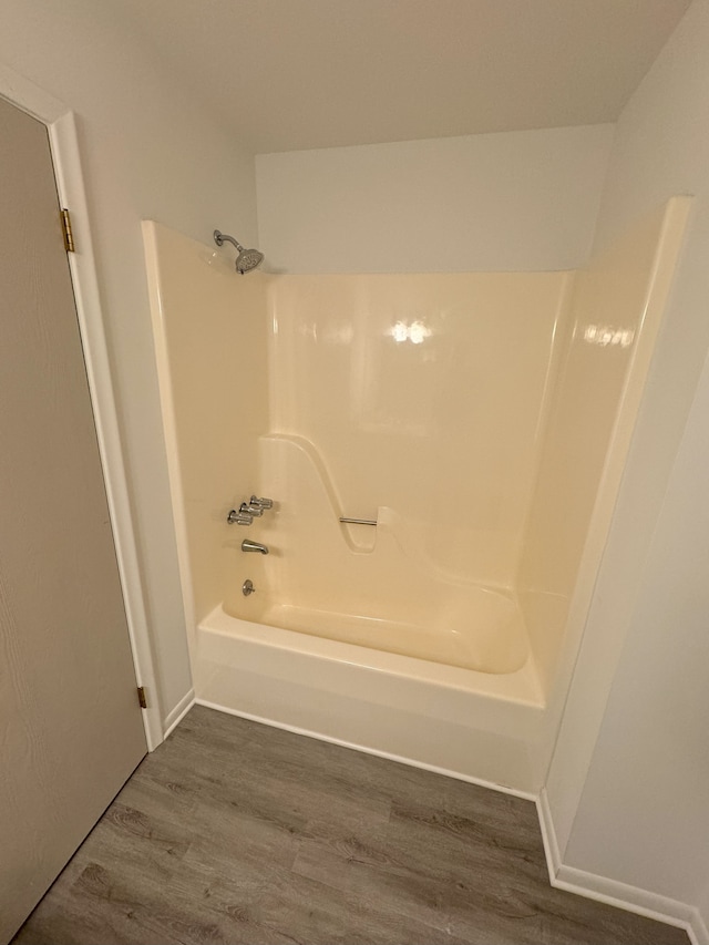 bathroom featuring hardwood / wood-style floors and shower / washtub combination