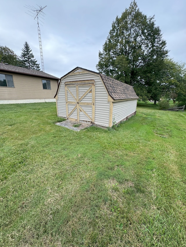 view of outbuilding featuring a lawn