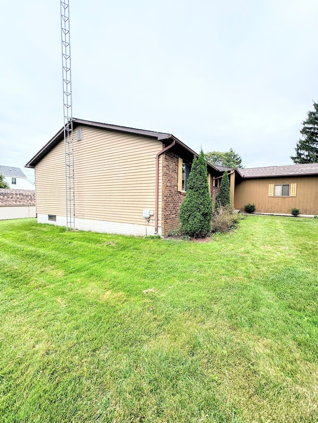 view of property exterior with a yard