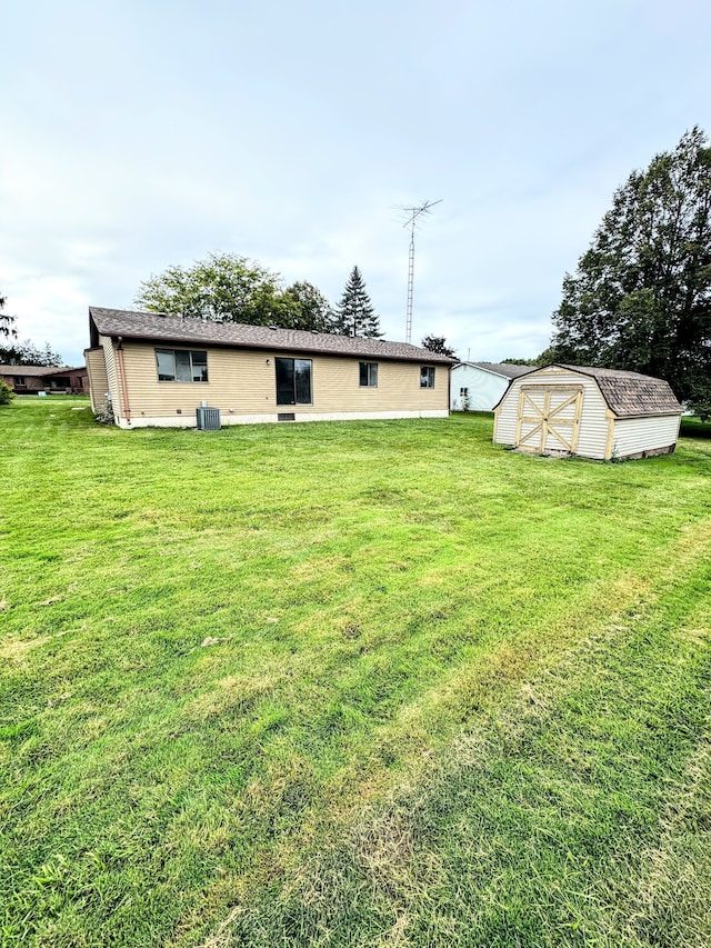 view of yard with central AC and a storage unit