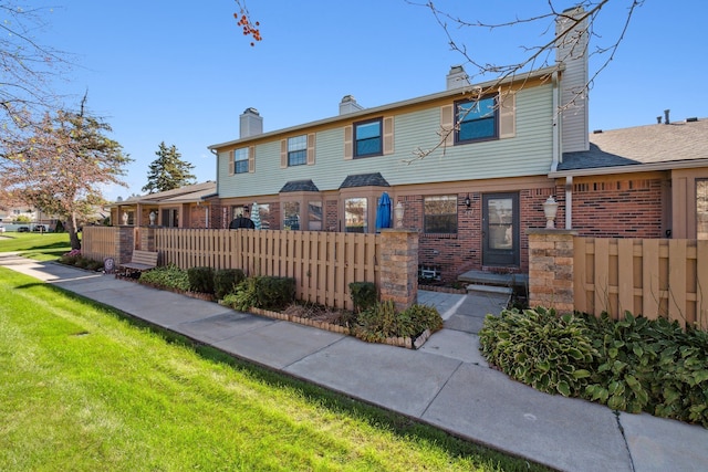 rear view of house with a yard