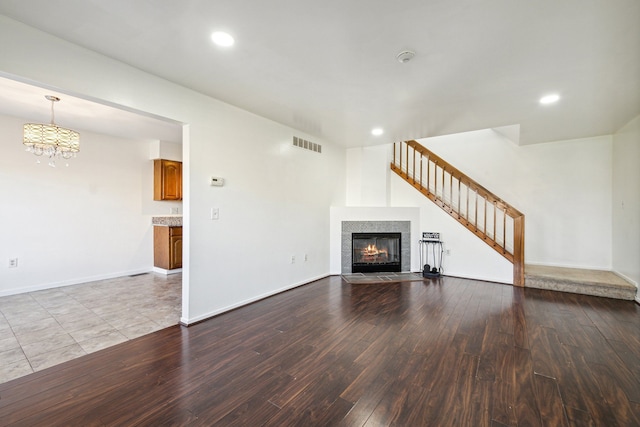 unfurnished living room featuring light hardwood / wood-style flooring and an inviting chandelier