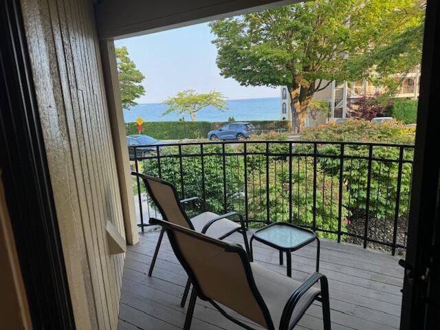 balcony featuring a water view