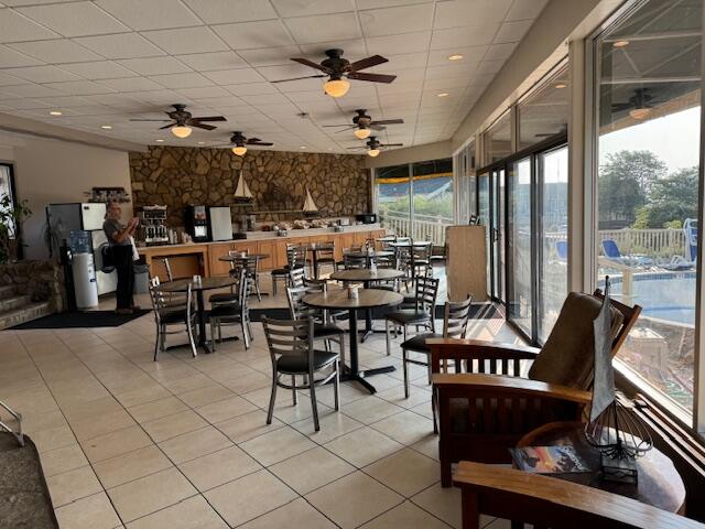 tiled dining room featuring ceiling fan