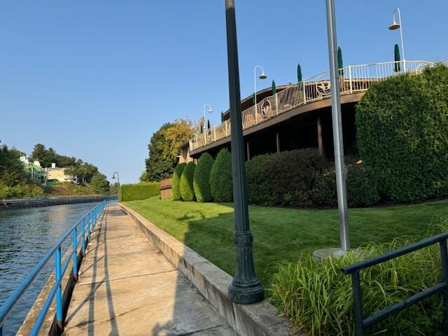 exterior space with a water view and a yard