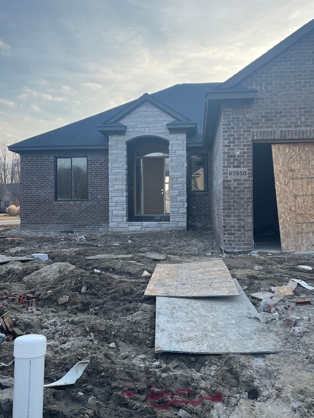 exterior space with brick siding and stone siding