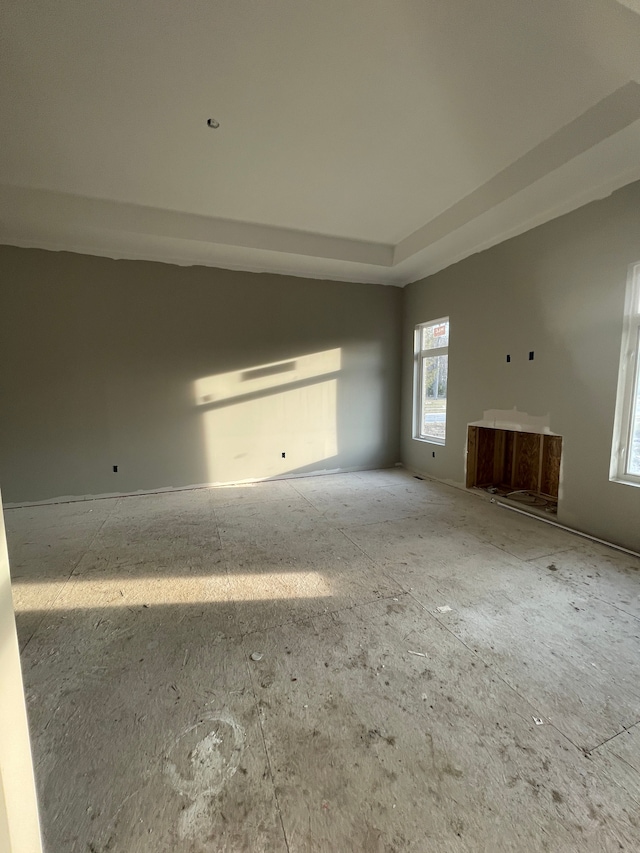 unfurnished living room with a raised ceiling