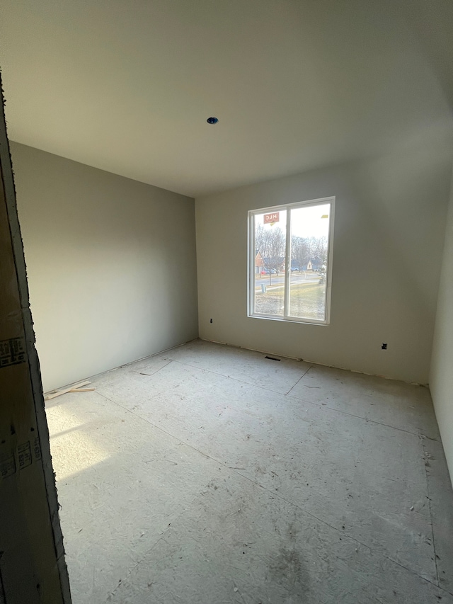 unfurnished room with visible vents