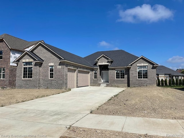 view of front of house with concrete driveway, a garage, and brick siding