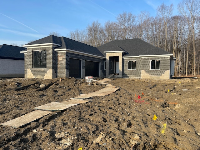 view of front of home with brick siding and an attached garage