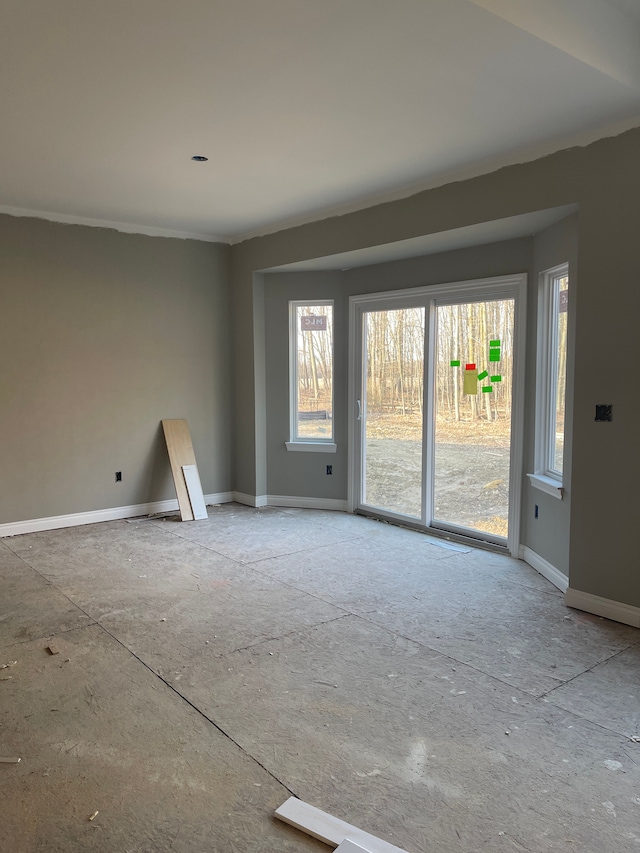 unfurnished room featuring baseboards